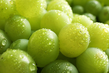 Bunch of green fresh ripe juicy grapes as background, closeup