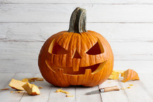Carved Halloween Pumpkin On White Boards, Holiday Decorations