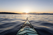 Sea Kayaking During A Vibrant Sunny Summer Sunset. Taken In Vancouver, BC, Canada.