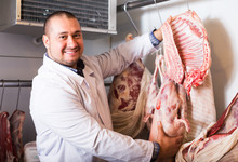 Butcher Cutting Fresh Lamb Meat