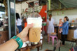 Hand hold fresh iced coffee in coffee cafe, blurred coffee cafe background