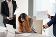 © fizkes - Depressed businesswoman feeling stressed bothered by male colleagues at work, female CEO suffer from headache or excessive workload annoyed by clients or subordinates, woman in despair manage anxiety