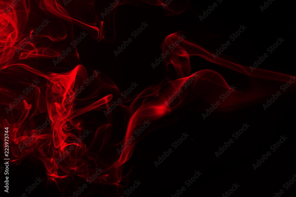 Movement of red smoke on black background Stock Photo | Adobe Stock