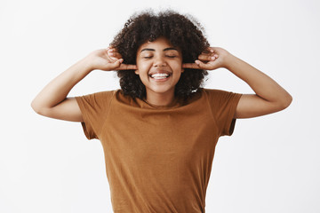 Wall Mural - living carefree life. happy and joyful emotive african american female with afro hairstyle in trendy