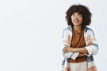 Wall Mural - indoor shot of trendy urban african american female employee in transparent trendy glasses and outfi