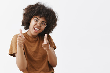 Wall Mural - bang bang you killed. cool and carefree playful dark-skinned female student in transparent glasses a