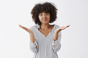 Wall Mural - waist-up shot of upset woman losing in battle shrugging with spread palms aside pursing lips and fro