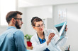 © Suteren Studio - Portrait of Woman Doctor at her Medical Office Looking at X-Ray with Patient