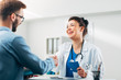 © Suteren Studio - Woman Doctor talking to Patient at her Medical Office
