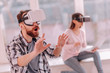 © zinkevych - Woohoo. Bearded nice man touching the air while using VR glasses resting at home