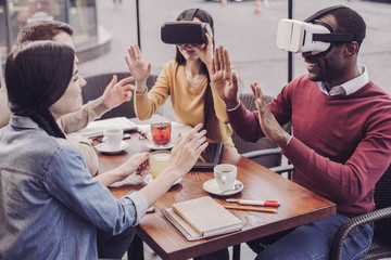 Wall Mural - Work in team. Delighted male person expressing positivity while testing VR mask