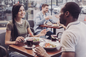 Wall Mural - Romantic atmosphere. Pleased girl expressing positivity while going to eat tasty salad