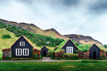 Wall Mural - traditional houses with grass on roof in iceland. landscape photography