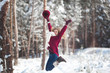 © olenachukhil - Young beautiful woman having fun in winter time outdoors