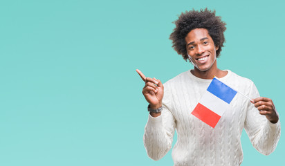 Afro american man flag of France over isolated background very happy pointing with hand and finger to the side