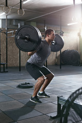 Workout At Gym. Sports Man Doing Squats With Barbell Row