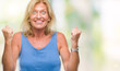 © Krakenimages.com - Middle age blonde woman over isolated background celebrating surprised and amazed for success with arms raised and open eyes. Winner concept.
