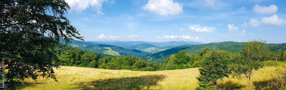 Wide panorama of a idyllic mountain landscape on a sunny day in the morning - obrazy, fototapety, plakaty 
