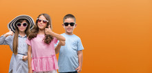 Group Of Boy And Girls Kids Over Orange Background Happy With Big Smile Doing Ok Sign, Thumb Up With Fingers, Excellent Sign