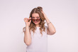 © satura_ - Portrait of enigmatic beautiful white girl fixing hair wearing sunglasses on white background