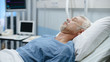 © Gorodenkoff - In the Hospital Sick Man Rests, Lying on the Bed. Recovering Man Sleeping in the Modern Hospital Ward.