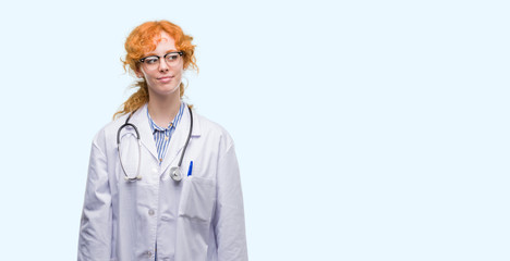 Canvas Print - Young redhead woman wearing doctor uniform smiling looking side and staring away thinking.