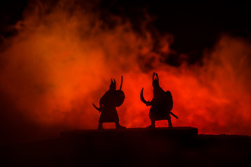 Silhouette of two samurais in duel. Picture with two samurais and sunset sky