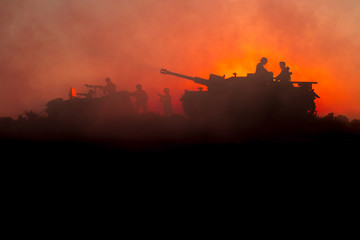 Wall Mural - War Concept. Military silhouettes fighting scene. World War German Tanks and soldiers silhouettes at sunset. Attack scene. Armored vehicles.