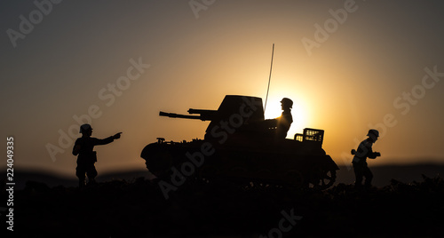 Obraz Dibond War Concept. Military silhouettes fighting scene. World War German Tanks and soldiers silhouettes at sunset. Attack scene. Armored vehicles.