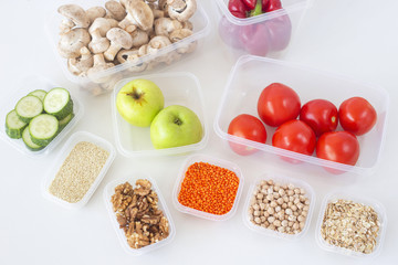 Storage of vegetarian food in plastic containers. Healthy eating. Order in the kitchen and in the fridge. Top view, flat lay