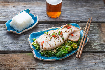 Wall Mural - Thai spicy squid salad with limes and beer