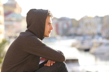 Teen boy contemplating a port on vacation