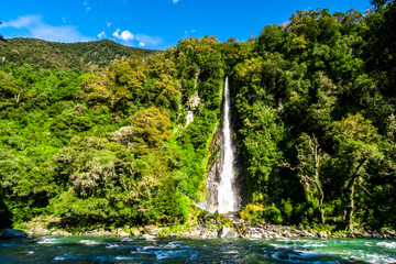 Poster - Thunder Creek Falls, Beautiful waterfall falling from the high mountain. Midday scenery with blue sky.