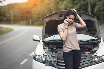 Wall Mural - Young woman with broken car calling for help.Vintage color