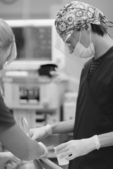 Wall Mural - Assistant doctor in uniform in the operating room on the background of medical equipment