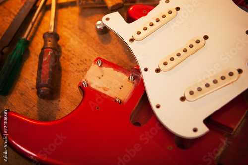 Red Electric Guitar On Guitar Repair Desk Or In A Repair Work