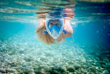 Woman Snorkeling With Full Face Mask In The Tropical Sea