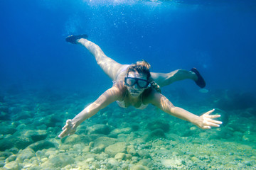 Wall Mural - Women diving in the tropical water, snorkeling with mask