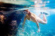 © leszekglasner - Young woman snorkeling underwater in the clear tropical water