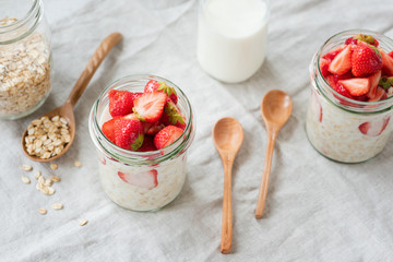overnight oats with strawberries and almond milk in a jar. healthy vegan vegetarian breakfast. bambo