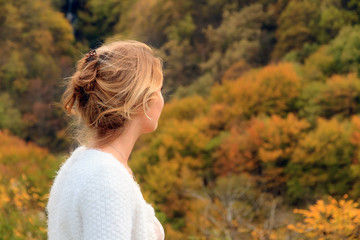 Wall Mural - Beautiful portrait of a gorgeous young woman in the mountains of the Rila national park in Bulgaria with vibrant autumn colors in the forest