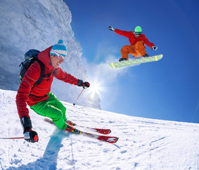 Wall Mural - Skier skiing downhill in high mountains against blue sky