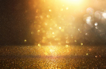 glitter vintage lights background. black and gold. de-focused.