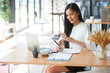 © Morakot - Protrait of Beautiful businesswoman sitting at desk and working with laptop computer.