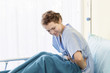 © Suthiporn - Beautiful young woman patient with period pain on hospital bed room.Copy space.