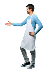 Wall Mural - A full-length shot of a Man wearing an apron handshaking after good deal on isolated background
