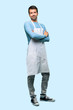 © luismolinero - Full body of Man wearing an apron making unimportant and doubts gesture while lifting the shoulders on blue background