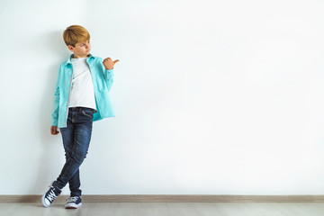 Wall Mural - The boy gesturing on the white wall background