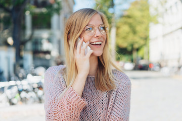 woman standing in the city using her mobile phone