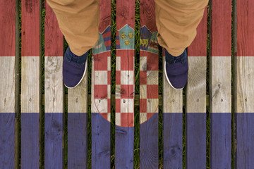 man stepped on a flag of Croatia painted on a wooden floor